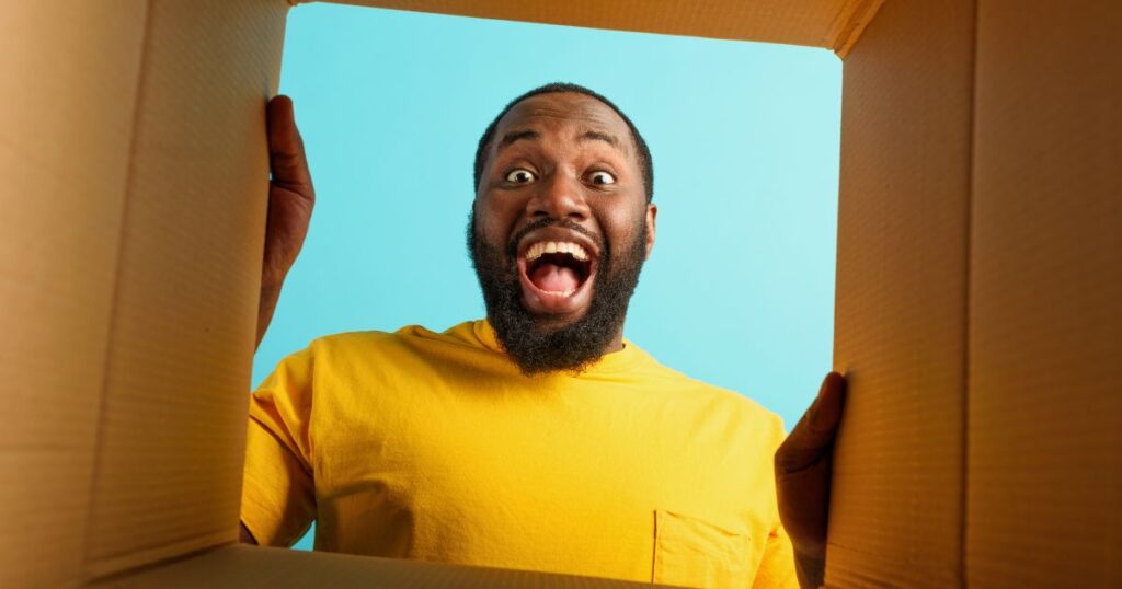 happy man looking through box