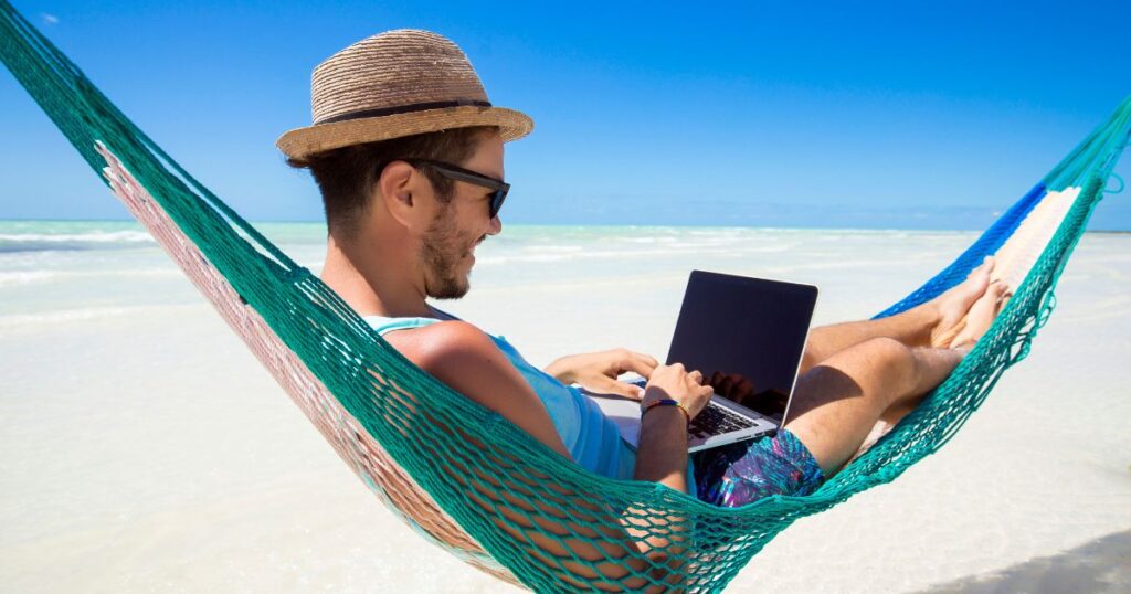 man working on laptop while on vacation