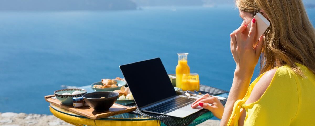 woman working on laptop while on vacation